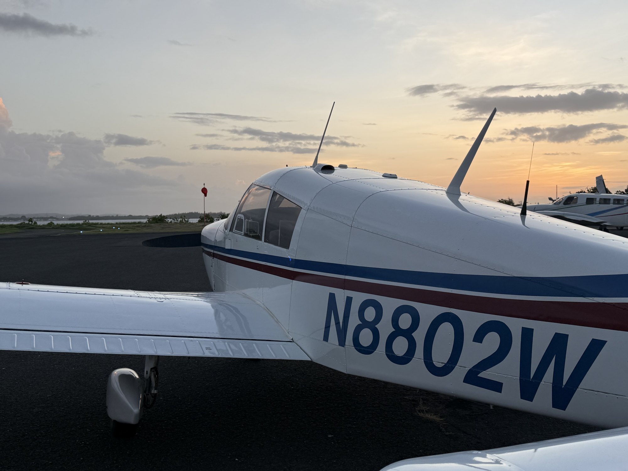N8802W on the ramp at Isla Grande at sunset, registration clearly visible